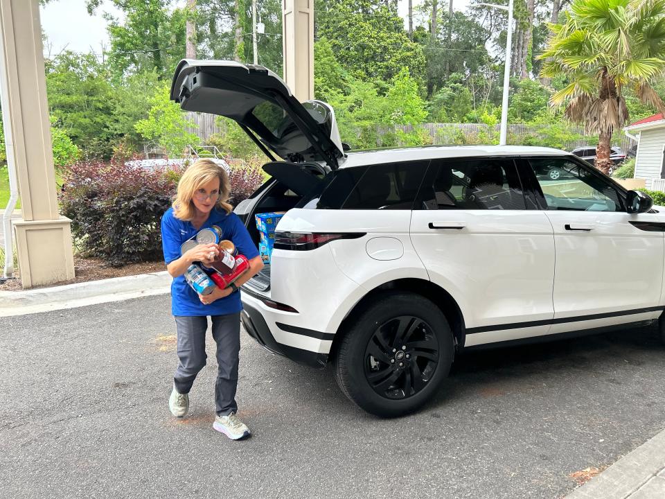 Rep. Allison Tant, D-Tallahassee, lugs jars of peanut butter from her car to the Brookestone Senior Living apartment complex in Tallahassee on Monday morning, May 13, 2024.