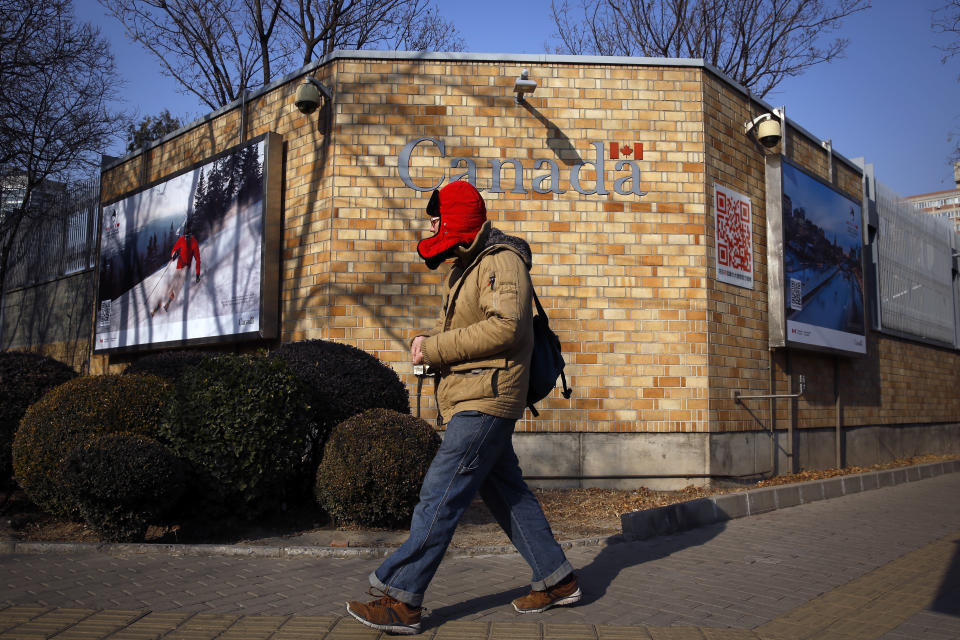 A man walks by the Canadian Embassy in Beijing, Friday, Dec. 14, 2018. Canada is being battered by diplomatic ill winds. First, President Donald Trump attacked Canada on trade. Then Saudi Arabia punished it for speaking up for human rights. Now China has the country in its cross-hairs, detaining two Canadians in apparent retaliation for the arrest of a top Chinese tech executive on behalf of the U.S. Canada's normally reliable ally to the south has left it high and dry. (AP Photo/Andy Wong)