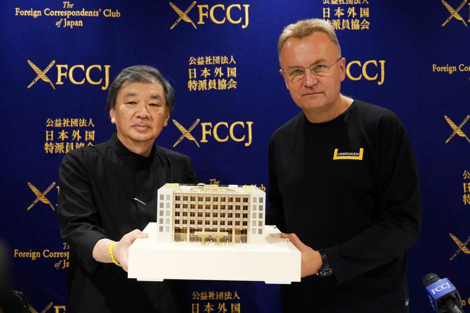 Andriy Sadovyy, right, the mayor of the Ukrainian city of Lviv, and architect Shigeru Ban hold a scale model of a rehabilitation center that is planned for Lviv.