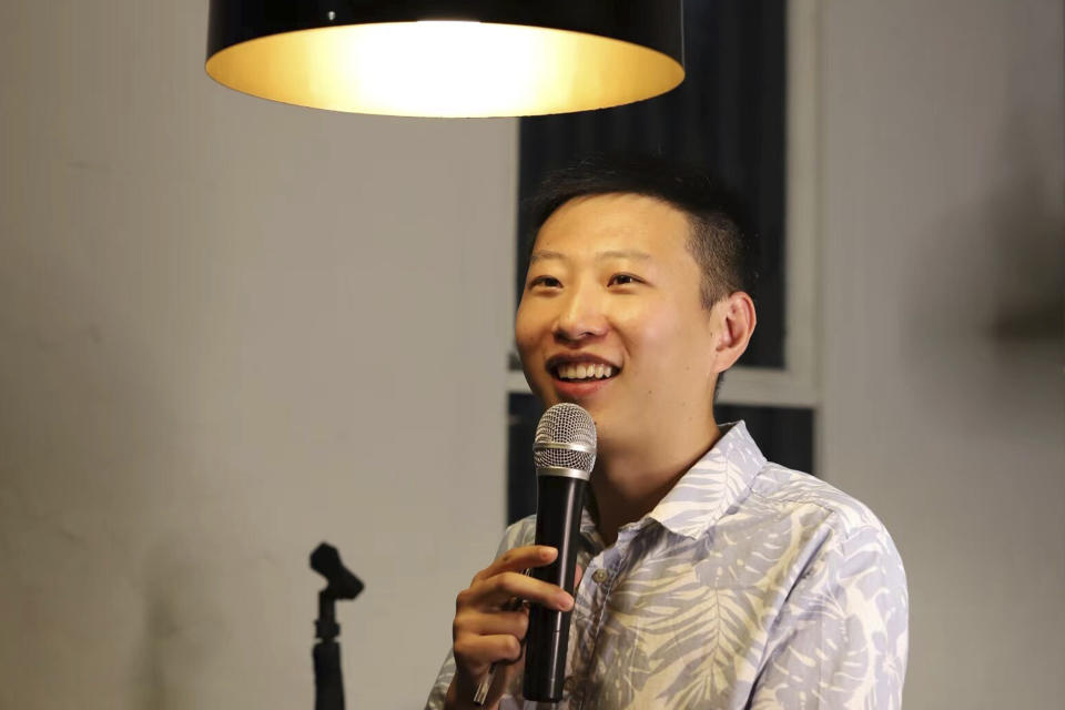 In this photo provided by Rena Gao, Xi Diao, a Chinese-born Australian civil engineer, performs standup comedy at a restaurant in Melbourne, Friday, March 18, 2022. (Rena Gao via AP）