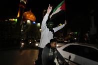 Iranian demonstrators wave a Palestinian flag during their anti-Israeli gathering at the Felestin (Palestine) Square in Tehran, Iran, early Sunday, April 14, 2024. Iran launched its first direct military attack against Israel Saturday. The Israeli military says Iran fired more than 100 bomb-carrying drones toward Israel. Hours later, Iran announced it had also launched much more destructive ballistic missiles. (AP Photo/Vahid Salemi)