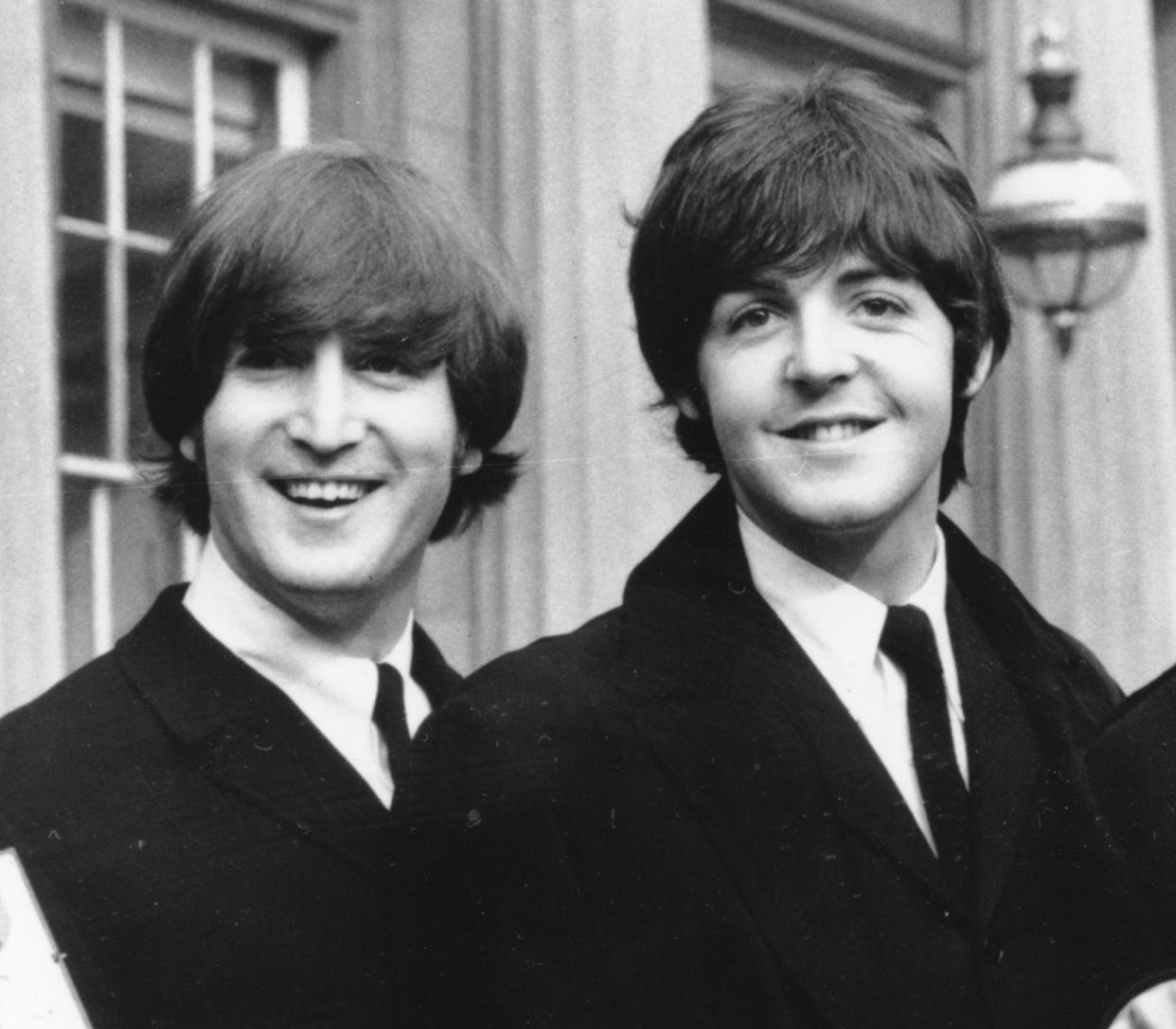 **FILE**   Beatles This Oct. 26, 1965 file photo shows John Lennon, left, and Paul McCartney as they smile during a ceremony at Buckingham Palace in London. The British Broadcasting Corp. will air a long lost Beatles interview featuring John Lennon and Paul McCartney talking about the day they met and their songwriting partnership. The precious film sat forgotten for 44 years in a garage in south London until film fan Richard Jeffs realized a piece of pop history was contained inside.    (AP Photo, FILE)