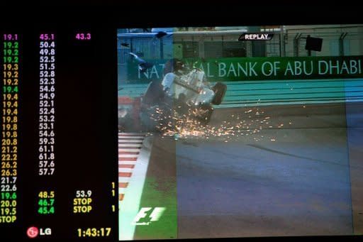 A giant screen shows Nico Rosberg (above) crashing his Mercedes into Narain Karthikeyan's Hispania during the Abu Dhabi Grand Prix. Rosberg was fortunate to walk away unscathed after the massive crash