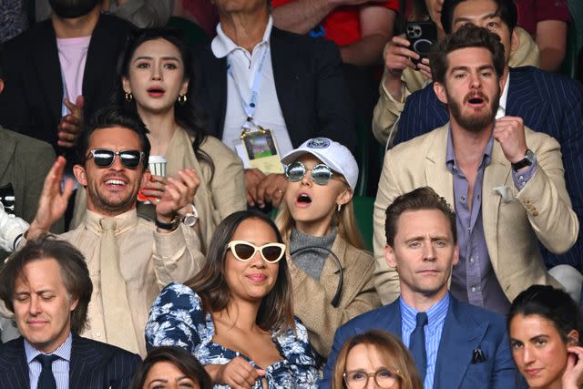 <p>Karwai Tang/WireImage</p> "Wicked" costars Jonathan Bailey and Ariana Grande react to the match at Wimbledon.