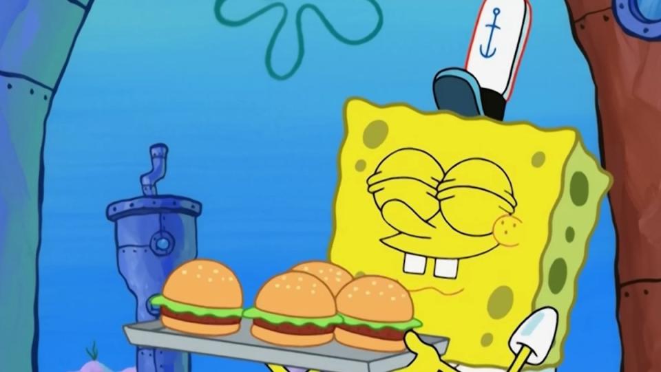 SpongeBob Squarepants smiling with his eyes closed while holding a tray of Krabby Patties