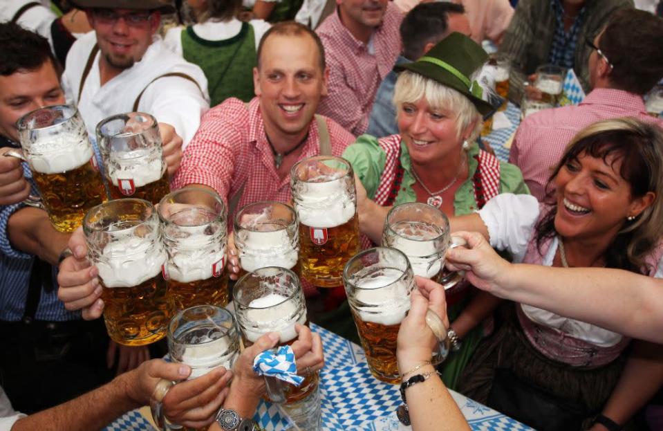 Visitors toast with beer mugs at a beer tent during the opening day of the Oktoberfest 2012 beer festival.