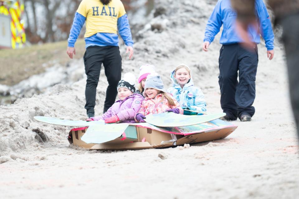 Sled team 'Seashell the Sea Turtle' finishes their run in the Festivus Cardboard Sled Competition at Leila Arboretum on Saturday, Feb. 10, 2024.