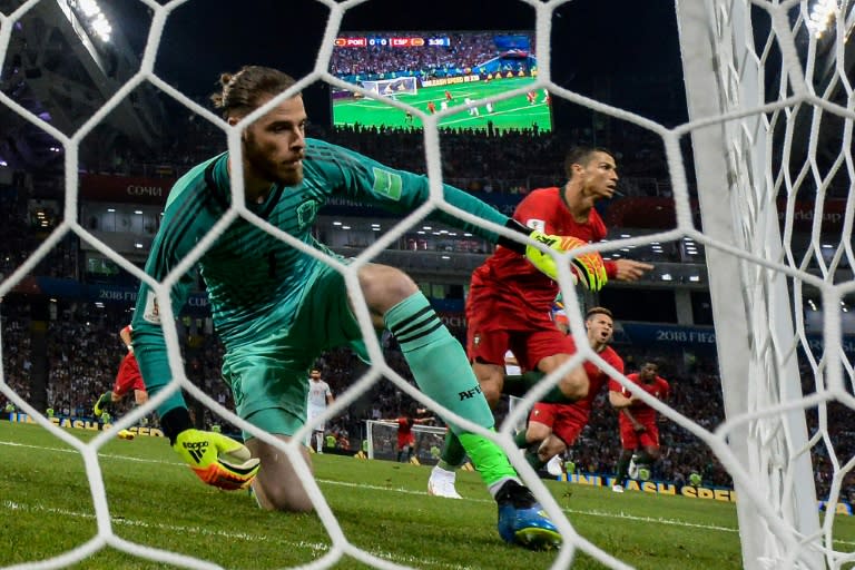 Cristiano Ronaldo (right) celebrates after scoring a penalty against Spain's goalkeeper David De Gea