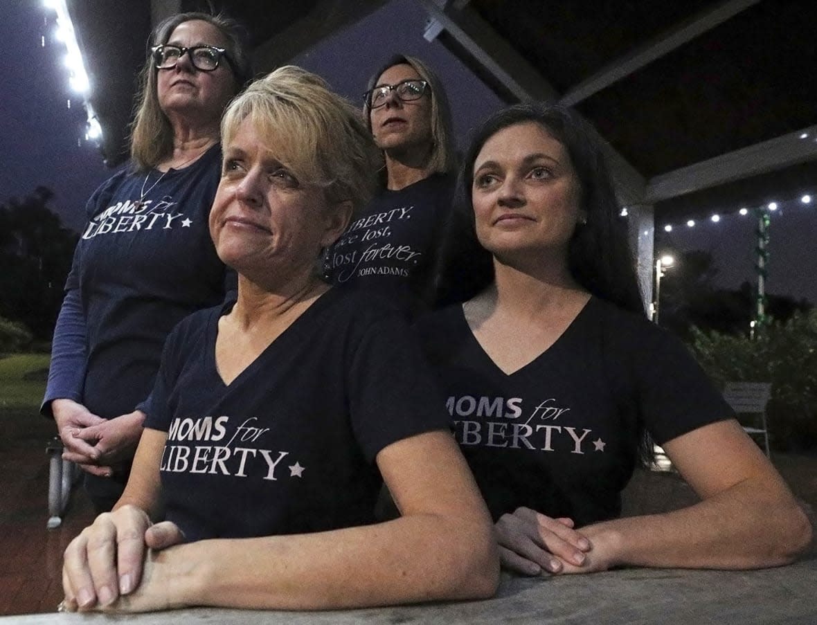 Moms for Liberty members, from left, Cheryl Bryant, Mishelle Minella, Kelly Shilson and Jessica Tillmann pose for a portrait at Reiter Park on Thursday, Nov. 18, 2021, in Longwood, Fla. (Chasity Maynard/Orlando Sentinel via AP, File)