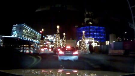 An image grab from a car dash camera shows a truck (L) driving into a Christmas market in Berlin, Germany on December 19, 2016. Private Dash Camera/via Reuters