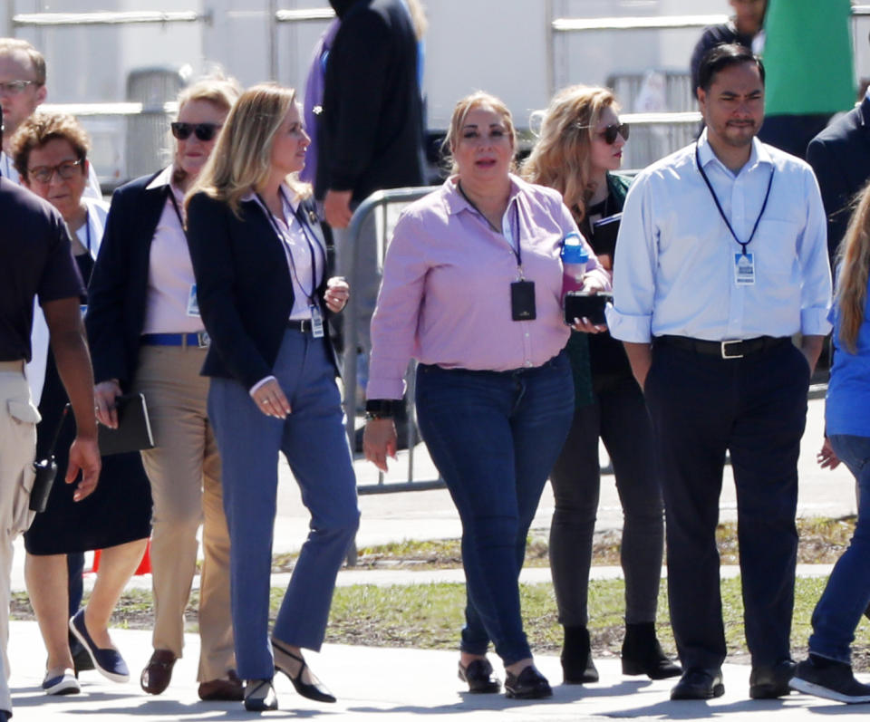 A woman with the Homestead Temporary Shelter for Unaccompanied Children, center, walks with Rep. Joaquin Castro, D-Texas, right, chairman of the Congressional Hispanic Caucus, Rep. Debbie Mucarsel-Powell, D-Fla., center left, Rep. Sylvia Garcia, D-Texas, second left, and Rep. Donna Shalala, far left, on a tour of the shelter, Tuesday, Feb. 19, 2019, in Homestead, Fla. (AP Photo/Wilfredo Lee)