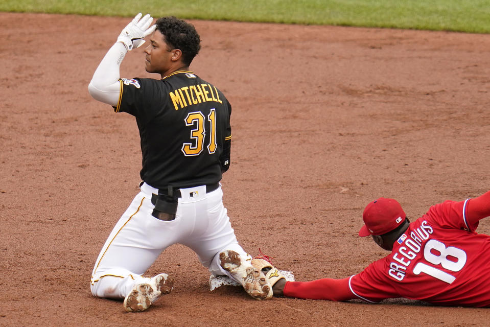 Pittsburgh Pirates' Cal Mitchell (31) celebrates after driving in a run with a double off Philadelphia Phillies starting pitcher Aaron Nola, as Phillies' Didi Gregorius (18) holds the tag during the third inning of a baseball game in Pittsburgh, Sunday, July 31, 2022. (AP Photo/Gene J. Puskar)