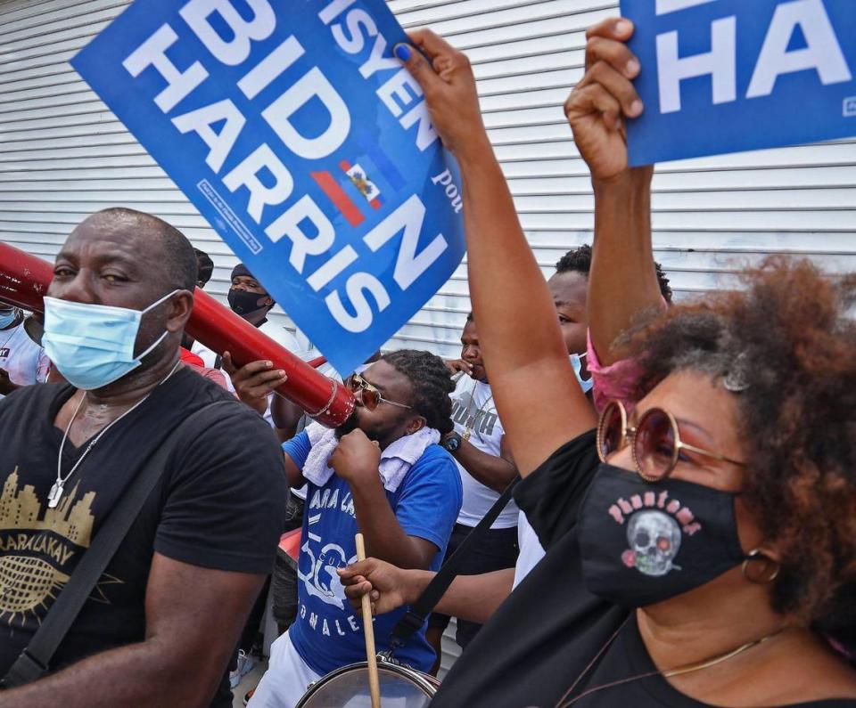 Haitian American supporters of Democratic presidential nominee Joe Biden dance and cheer as they lined the streets of Northeast Second Avenue and 59th Street in Little Haiti hoping to catch a glimpse of the visit of the candidate as he arrived at the Little Haiti Cultural Center on Monday. Biden courted Haitian-American leaders and voters on the last day to register to vote in Florida for the Nov. 3 presidential election on Monday, October 5, 2020.