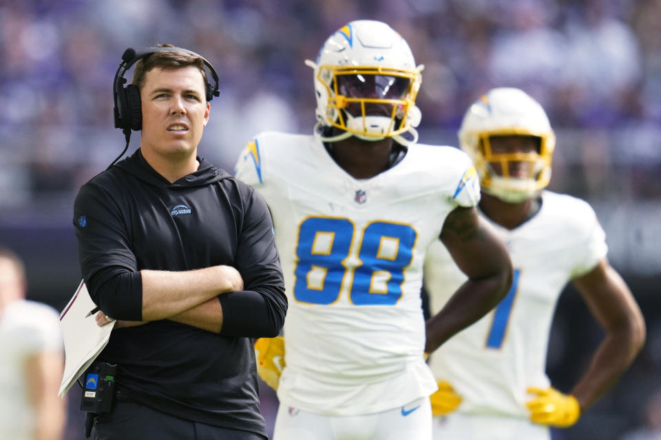 FILE - Los Angeles Chargers offensive coordinator Kellen Moore, left, stands on the field during the first half of an NFL football game against the Minnesota Vikings on Sept. 24, 2023, in Minneapolis. Moore has been under the spotlight since he was named the Los Angeles Chargers offensive coordinator in late January. (AP Photo/Abbie Parr, File)