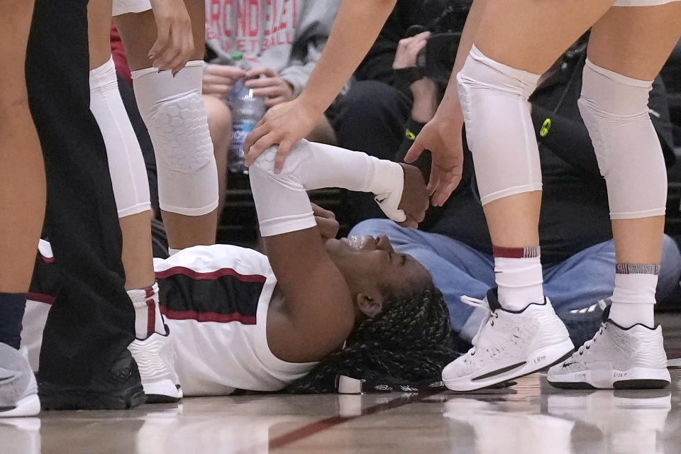 Stanford forward Francesca Belibi reacts as she lies on the court after a collision with Arizona guard Jade Loville during the second half of an NCAA college basketball game Monday, Jan. 2, 2023, in Stanford, Calif. (AP Photo/Tony Avelar)