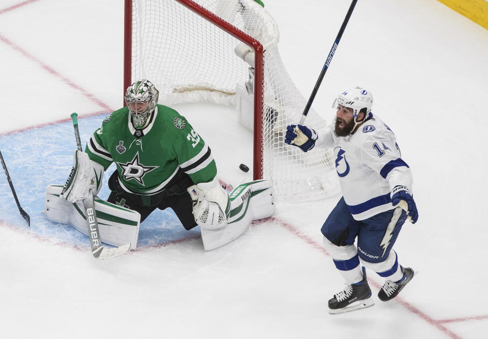 Dallas Stars goaltender Anton Khudobin (35) and Tampa Bay Lightning's Pat Maroon, right, react to a goal by Lightning's Kevin Shattenkirk during overtime of Game 4 of the NHL hockey Stanley Cup Final, Friday, Sept. 25, 2020, in Edmonton, Alberta. (Jason Franson/The Canadian Press via AP)