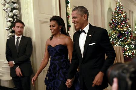 U.S. President Barack Obama and first lady Michelle Obama arrive at the Kennedy Center Honors Reception at the White House in Washington December 6, 2015. REUTERS/Yuri Gripas