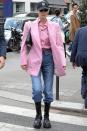 <p>In a pink Vivienne Westwood shirt and blazer with high-waisted jeans, Prada boots and a New York Yankees baseball cap. <br></p>