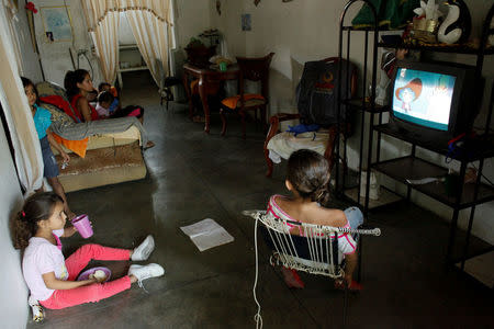 Grandchildren of Carmen Penaloza watch TV at their home in San Cristobal, Venezuela February 22, 2018. REUTERS/Carlos Eduardo Ramirez/Files