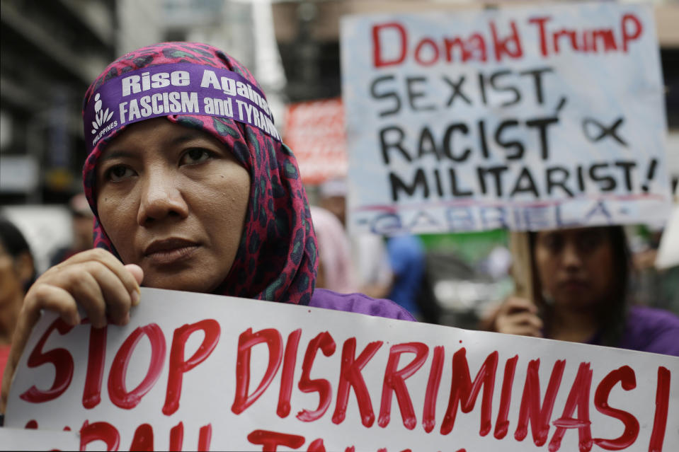 <p>Nur, a protester from Indonesia, holds a sign during a rally as they tried to march near the U.S. Embassy in Manila, Philippines to protest the upcoming visit of President Donald Trump on Thursday, Nov. 9, 2017. (Photo: Aaron Favila/AP) </p>