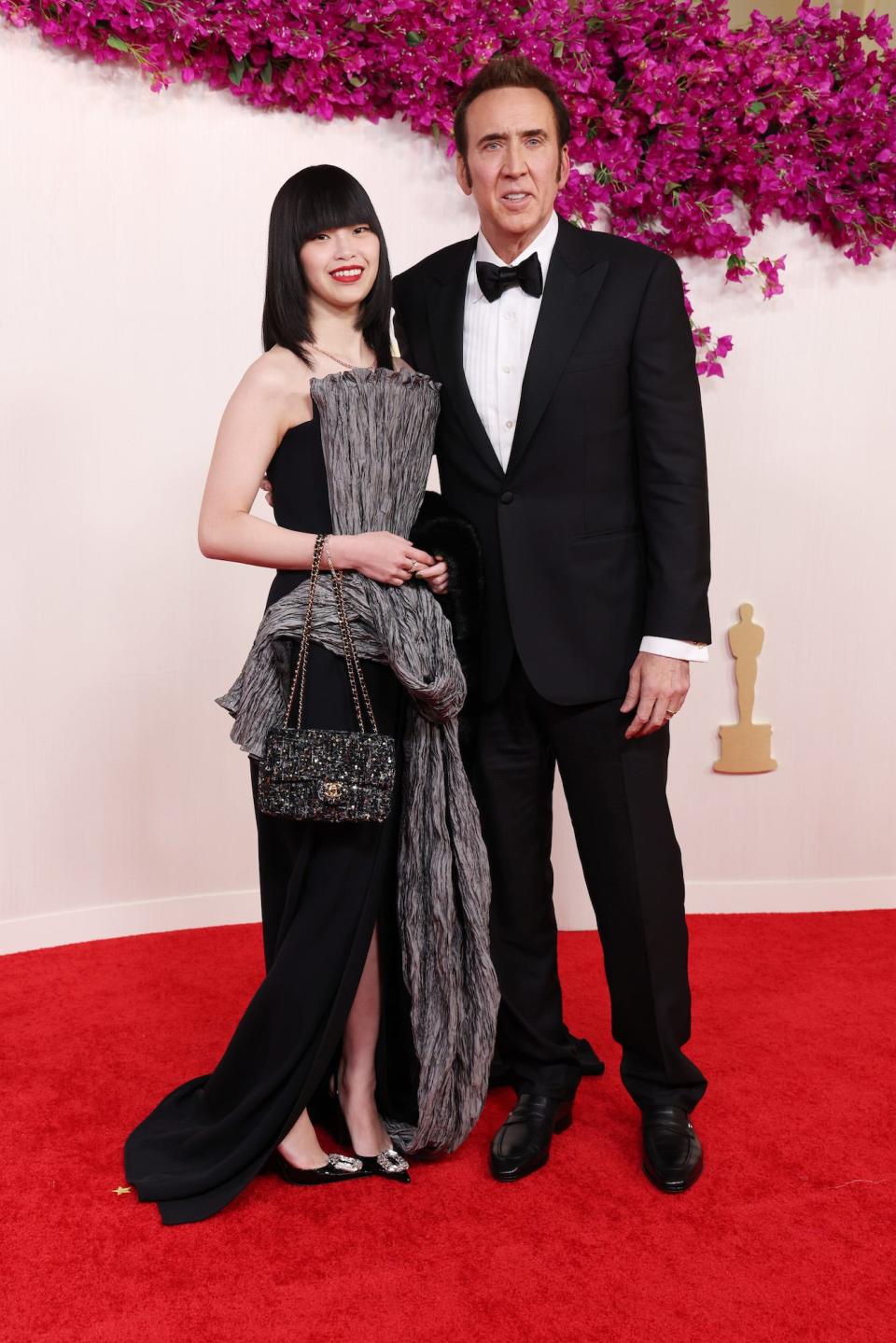 Riko Shibata and Nicolas Cage attend the 96th Annual Academy Awards.