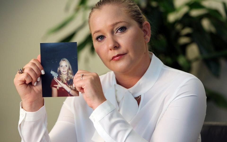 Virginia Roberts holds a photo of herself at age 16, when she says Palm Beach multimillionaire Jeffrey Epstein began abusing her sexually. - Getty