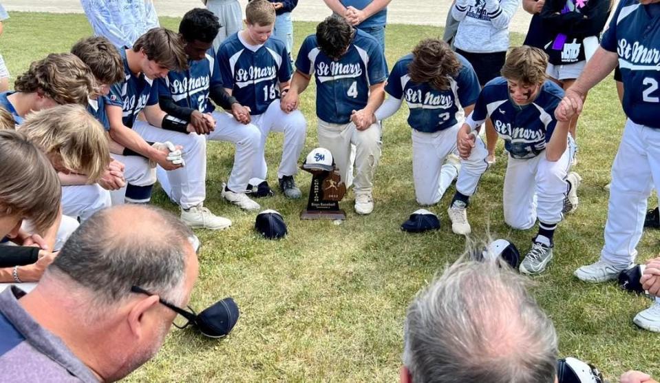 Gaylord St. Mary baseball team joins in prayer after winning the Division 4 district championship on Saturday, June 4.
