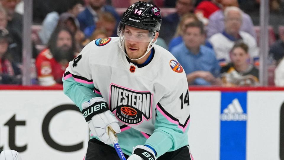 Feb 4, 2023;  Sunrise, Florida, USA;  Central Division forward Cale Makar (8) of the Colorado Avalanche reaches for the puck against Pacific Division forward Bo Horvat (14) of the New York Islanders during the first period of a semifinal game during the 2023 NHL All-Star Game at FLA Live Arena. .