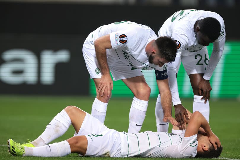 Gonçalo Inácio and Ousmane Diomande of Sporting CP look over team mate Pedro Goncalves of Sporting CP as he lays injured after scoring to give the side a 1-0 lead during the UEFA Europa League 2023/24 round of 16 second leg match between Atalanta BC and Sporting CP at Stadio Di Bergamo on March 14, 2024 in Bergamo, Italy.