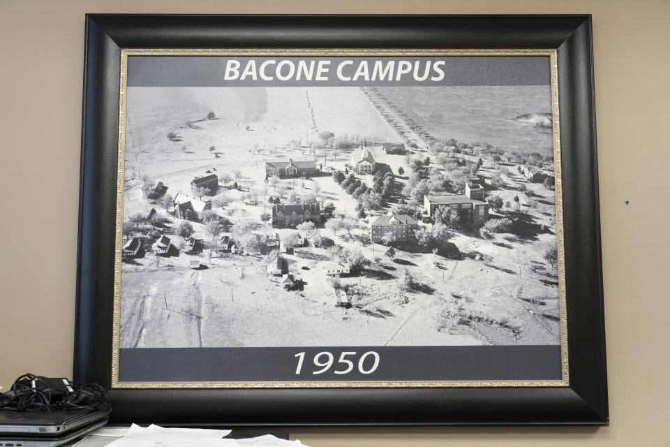 An old photo of the campus is displayed in the administration offices at Bacone College, on Jan. 8 2024, in Muskogee, Okla. Founded in 1880 as a Baptist missionary college focused on assimilation, Bacone College transformed into an Indigenous-led institution that provided an intertribal community, as well as a degree. (AP Photo/Nick Oxford)
