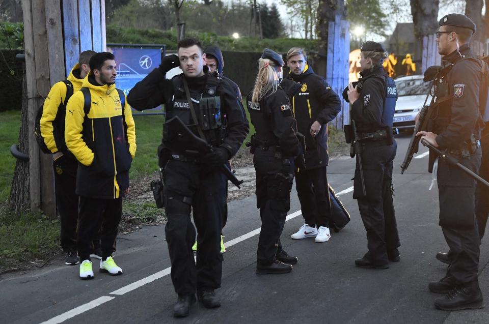 <p>Borussia Dortmund’s Marcel Schmelzer speaks to police after an explosion went off near the German team’s bus </p>