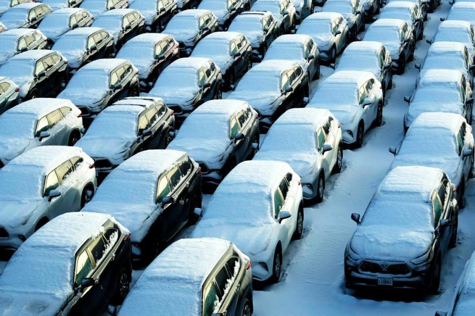 Snow covered vehicles sit in a rental car parking lot Sunday at the O’Hare International Airport in Chicago. Wind chill warning is in effect as dangerous cold conditions continue in the Chicago area.