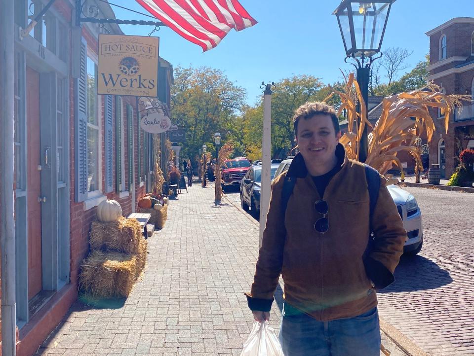 alexis' partner holding a bag of takeout food on an american street