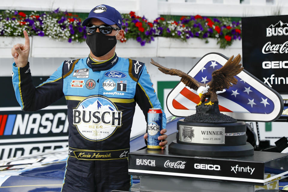 Kevin Harvick celebrates in the winners circle after winning the NASCAR Cup Series auto race at Pocono Raceway, Saturday, June 27, 2020, in Long Pond, Pa. (AP Photo/Matt Slocum)