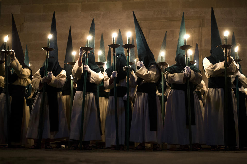 <p>Penitents from Las Siete Palabras brotherhood take part in a procession in Zamora, Spain, April 16, 2014. Hundreds of processions take place throughout Spain during the Easter Holy Week. (AP Photo/Andres Kudacki) </p>