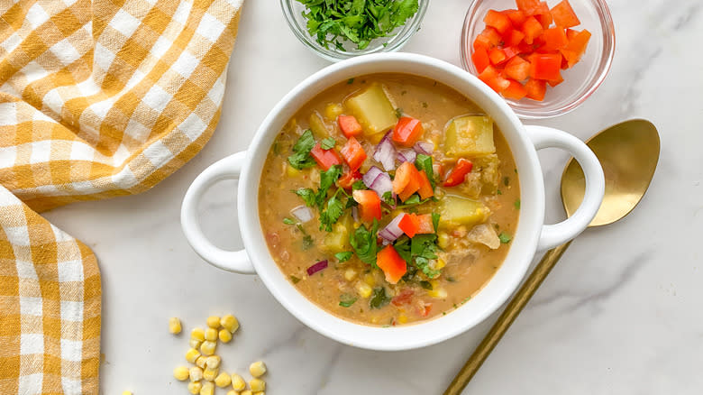 bowl of chowder with brass spoon