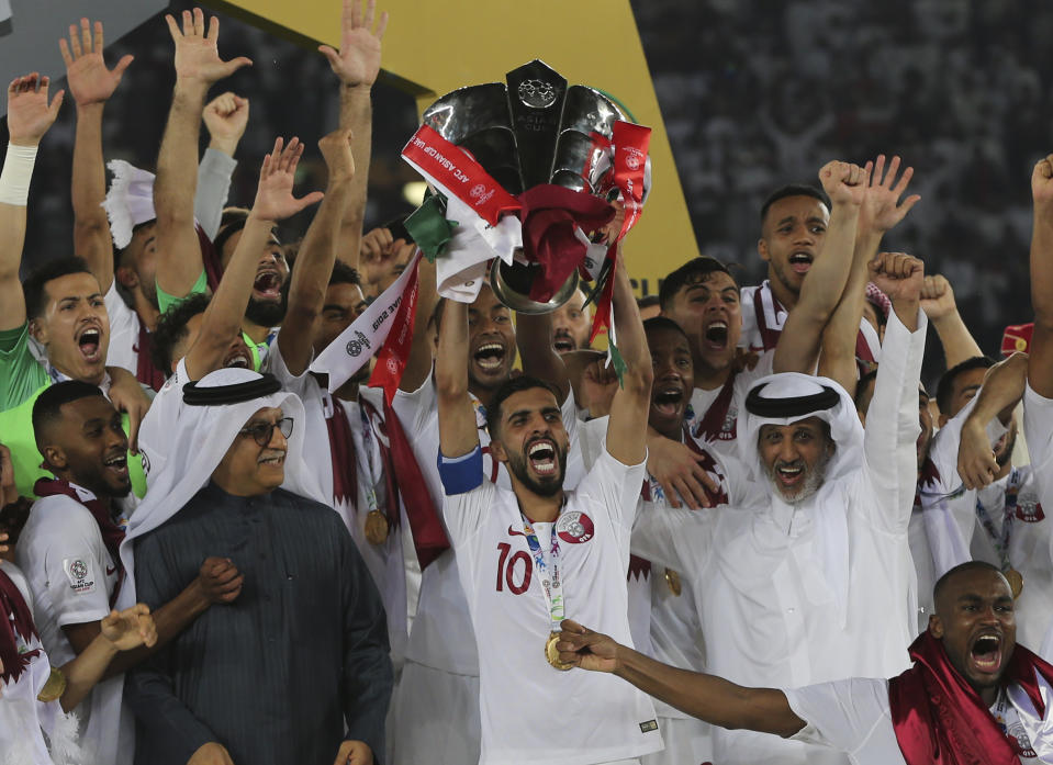 Qatar\s players lift the trophy after winning the AFC Asian Cup final match between Japan and Qatar in Zayed Sport City in Abu Dhabi, United Arab Emirates, Friday, Feb. 1, 2019. (AP Photo/Kamran Jebreili)