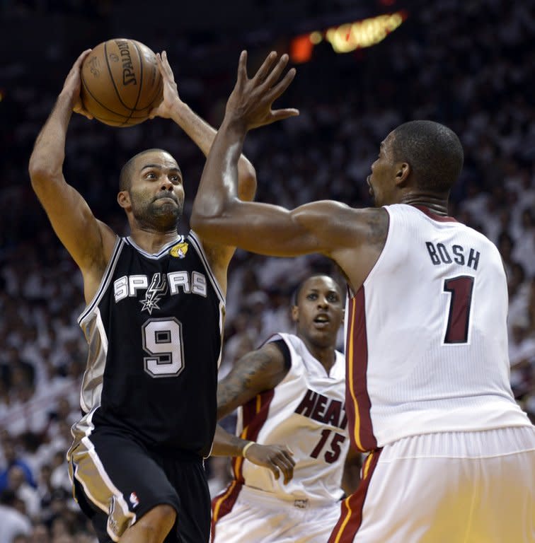 Chris Bosh (R) of the Miami Heat guards Tony Parker of the San Antonio Spurs during their game on June 9, 2013. Bosh finished with 12 points and 10 rebounds and veteran Ray Allen came off the bench to score 13 points for Miami