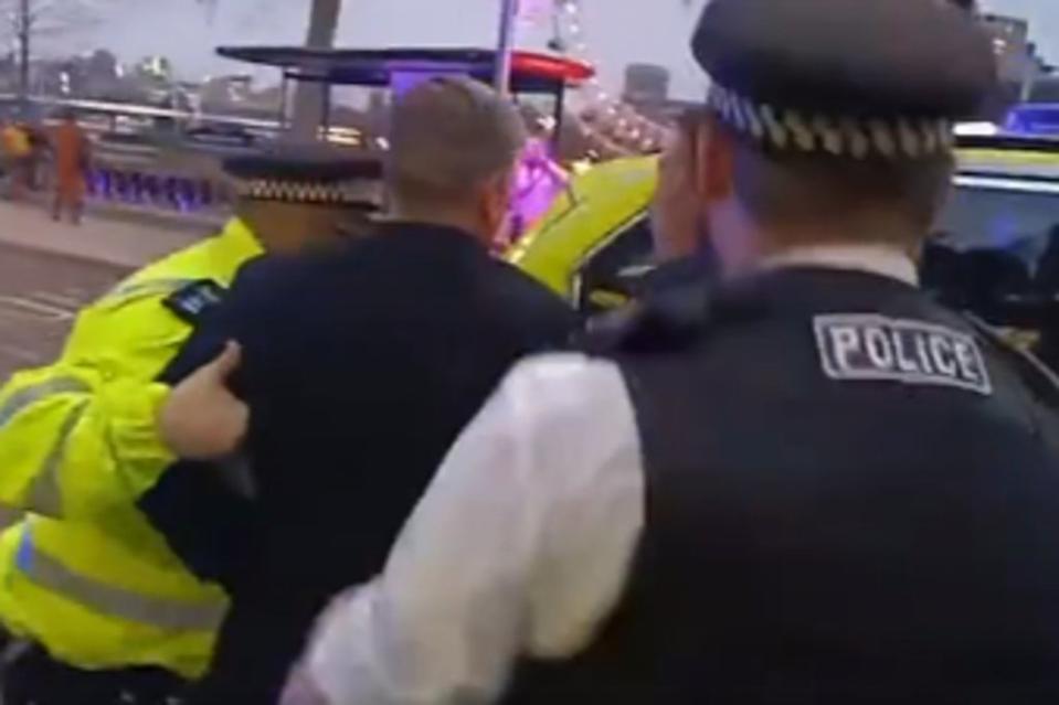 Sir Keir Starmer is led into a police car by officers (Twitter)