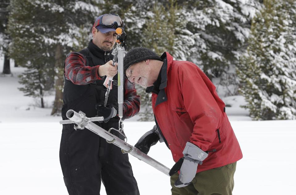 Frank Gehrke, right, chief of the California Cooperative Snow Surveys Program for the Department of Water Resources, checks the snowpack weight on a scale held by John Paasche, of DWR, during the first snow survey of the season at Phillips Station Tuesday, Jan. 3, 2017, in Echo Summit, Calif. The survey showed the snowpack at 53 percent of normal for this site at this time of year. (AP Photo/Rich Pedroncelli)