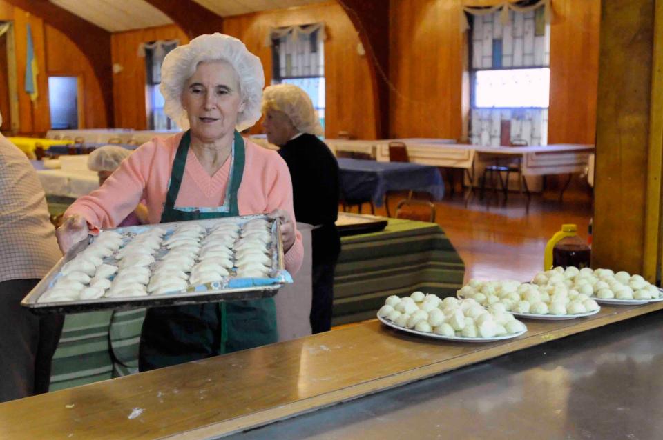 Tina Russell / Observer - Dispatch
Gloria Jakubowski takes pierogies to the counter to be cooked for the Ukrainian Festival Wednesday, Oct. 17, 2012.