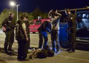 A policeman checks a Syrian migrant on September 13, 2015, in the southern German city of Freilassing at the border between Germany and Austria