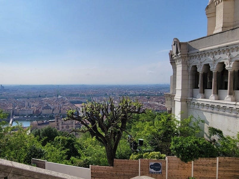 View of buildings and treetops from a balcony