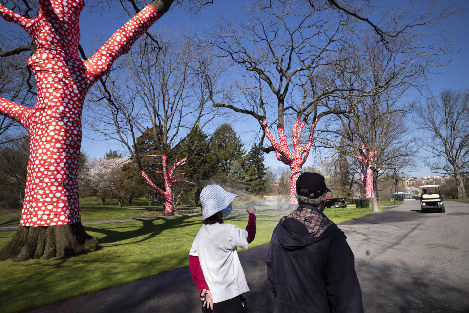 The sculpture "Ascension of Polka Dots on the Trees" by Japanese artist Yayoi Kusama is on display at the New York Botanical Garden, Thursday, April 8, 2021 in the Bronx borough of New York. The expansive exhibit has opened, and ticket sales have been brisk in a pandemic-weary city hungry for more outdoor cultural events. (AP Photo/Mark Lennihan)