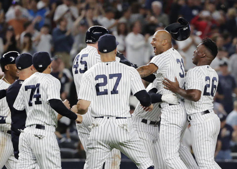 New York Yankees' Aaron Hicks (31) celebrates with teammates after hitting an RBI double during the eleventh inning of a baseball game against the Baltimore Orioles Saturday, Sept. 22, 2018, in New York. The Yankees won 3-2. (AP Photo/Frank Franklin II)