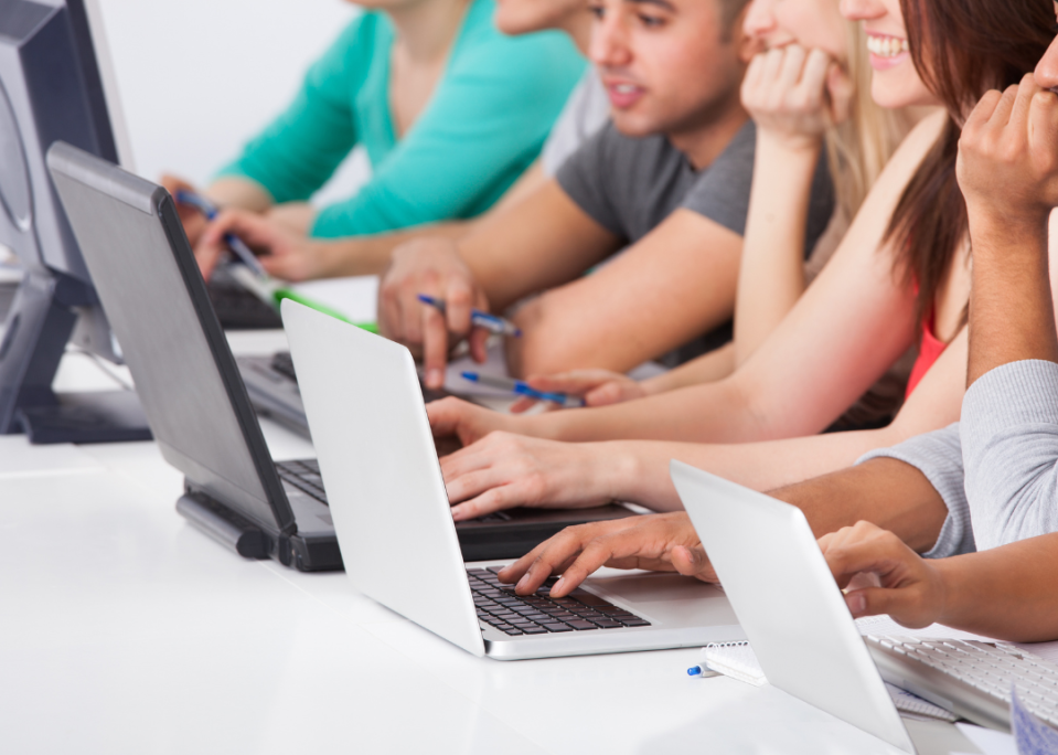 A group of college students working on their laptops.