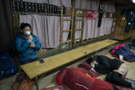 A man inhales oxygen in a mountain hut while getting ready to climb to the summit of Mount Fuji to watch the sunrise, Saturday, Aug. 3, 2019, in Japan. (AP Photo/Jae C. Hong)