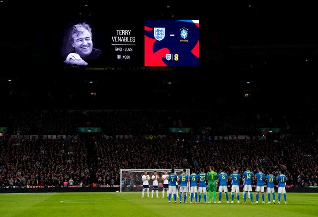 Players and fans take part in a minute’s applause in memory of former England manager Terry Venables