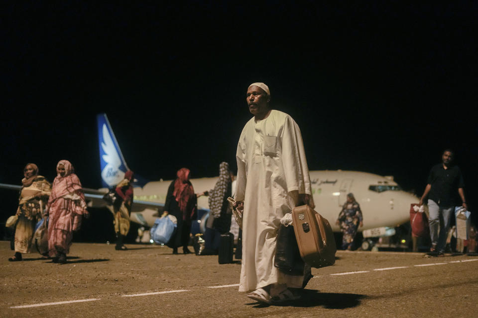 Sudanese, who had been stranded in Jeddah, Saudi Arabia, arrive at Port Sudan airport, Thursday, May 11, 2023. The conflict between the country's military and a rival paramilitary group has killed hundreds and displaced hundreds of thousands since it broke out in mid-April, creating a humanitarian crisis inside the country and at its borders. (AP Photo/Amr Nabil)