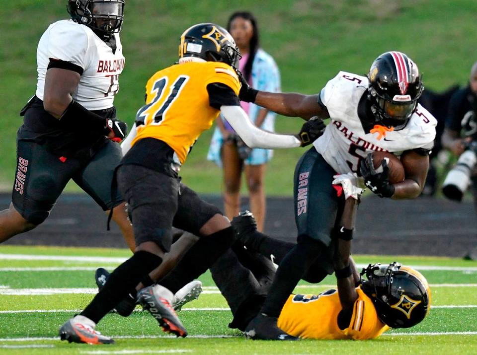 Badlwin’s Micah Welch (5) runs for a first down during the Braves’ win over Peach County Friday night.